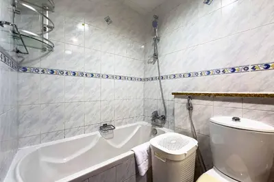 a bathroom with a white tub and a toilet at Chill Studio with Balcony and Pool View in Dubai