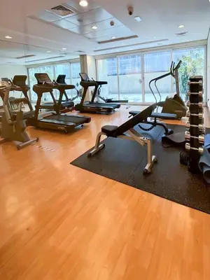 a gym with several exercise bikes in a room at Chill Studio with Balcony and Pool View in Dubai