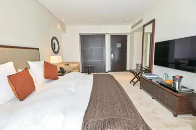 a large bedroom with a large bed and a television at Studio on the 30th Floor with Stunning Marina View in Dubai