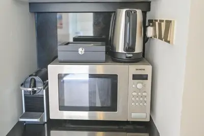 a microwave with a coffee maker on top of it at Studio on the 30th Floor with Stunning Marina View in Dubai
