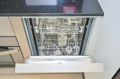 a dishwasher in a kitchen with its door open at Studio on the 30th Floor with Stunning Marina View in Dubai