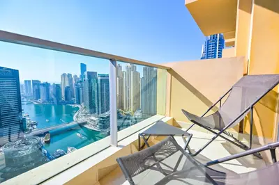 a balcony with a chair and a view of the city at Studio on the 30th Floor with Stunning Marina View in Dubai