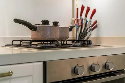 a pot on top of a stove in a kitchen at FIRST CLASS 1BR Spacious Comfort Awaits in Dubai