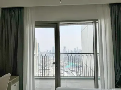 a hotel room with a balcony with sliding glass doors at DVR 4 BR Apartment available in Downtown View 2 in Dubai