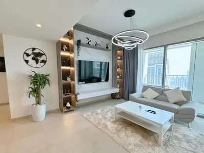 a living room with a couch and a table at DVR 4 BR Apartment available in Downtown View 2 in Dubai