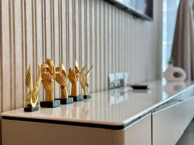 a table with a bunch of wooden statues on it at Brand New - Fully Furnished Premium 1BR in JVC in Dubai