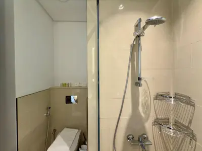 a bathroom with a shower with a glass door at Brand New - Fully Furnished Premium 1BR in JVC in Dubai