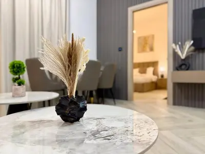 a vase with feathers sitting on top of a table at Brand New-Fully Furnished Elegant 1BR In JVC in Dubai