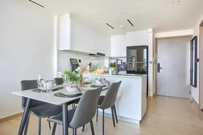 a kitchen and dining room with a table and chairs at Frank Porter - Binghatti Corner in Dubai