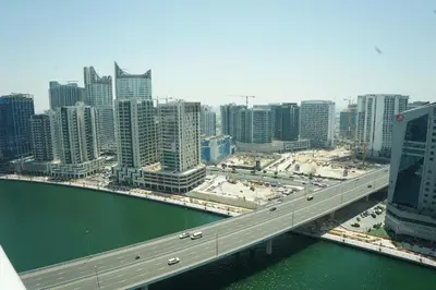a bridge over a river in a city with buildings at Luxury 2BR Stay In Damac Prive near Dubai Mall in Dubai