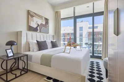 a bedroom with a large bed and a large window at Frank Porter - Azizi Riviera 15 in Dubai