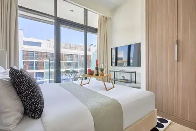a bedroom with a bed and a large window at Frank Porter - Azizi Riviera 15 in Dubai