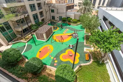 an aerial view of a park with a playground at Vibrant 1BR APT with Burj Khalifa View in Dubai