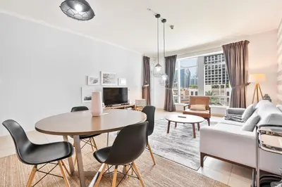 a living room with a table and a couch at Vibrant 1BR APT with Burj Khalifa View in Dubai