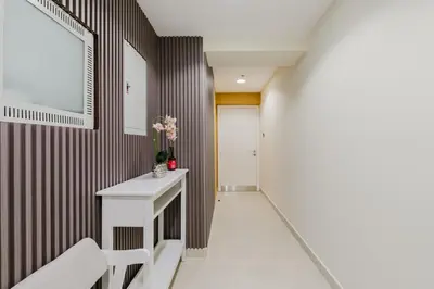 a hallway with a white table and chairs at RH- Heart of Dubai Marina, Sunny & bright 2 BR apartment with big balcony in Dubai