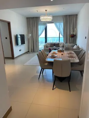 a living room with a table and a couch at Vida Dubai Marina Apartment at Prime Location in Dubai