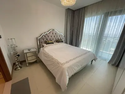 a bedroom with a large bed with a large window at Vida Dubai Marina Apartment at Prime Location in Dubai