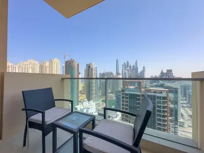 two chairs and a table on a balcony with a view at AWS Holiday Homes - Views from the Sky in Dubai