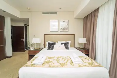 a bedroom with a large white bed with two lamps at AWS Holiday Homes - Views from the Sky in Dubai