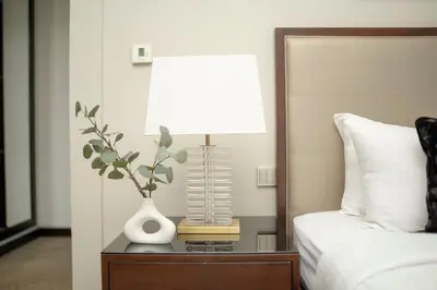 a bedroom with a bed and a table with a lamp at AWS Holiday Homes - Views from the Sky in Dubai