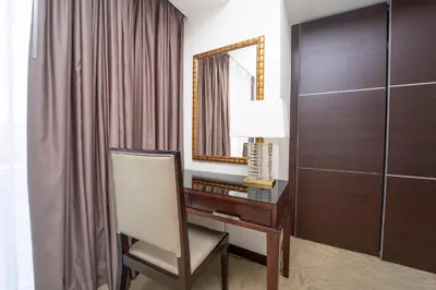 a room with a desk with a mirror and a chair at AWS Holiday Homes - Views from the Sky in Dubai