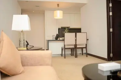 a living room with a couch and a table at AWS Holiday Homes - Views from the Sky in Dubai