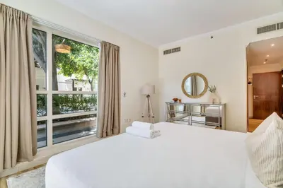 a bedroom with a white bed and a large window at GuestReady - Contemporary living in Dubai Marina in Dubai