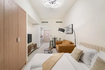 a bedroom with a bed and a living room at FIRST CLASS Studio Urban Elegance in Dubai