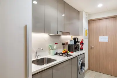 a kitchen with a sink and a washing machine at FIRST CLASS Studio Urban Elegance in Dubai