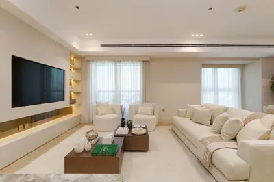 a living room with a large couch and a flat screen tv at Daniels 4BR At Princess Tower with Marina and Sea view in Dubai