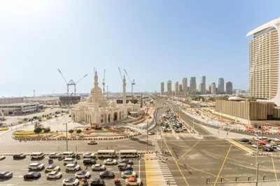 a city with cars parked in a parking lot at Daniels 4BR At Princess Tower with Marina and Sea view in Dubai