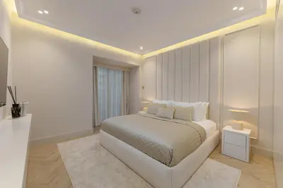 a white bedroom with a bed and a window at Daniels 4BR At Princess Tower with Marina and Sea view in Dubai