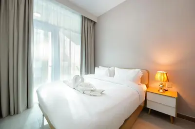 a bedroom with a bed with a stuffed animal on it at Stylish 2BR Apartment by Missoni near Dubai Mall in Dubai