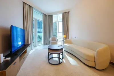 a living room with a couch and a television at Stylish 2BR Apartment by Missoni near Dubai Mall in Dubai