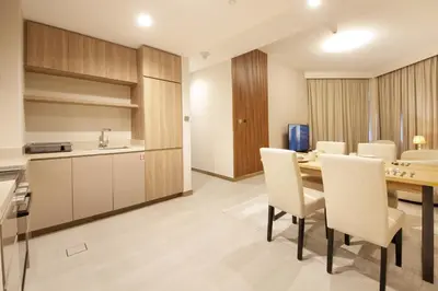 a kitchen and dining room with a table and chairs at Stylish 2BR Apartment by Missoni near Dubai Mall in Dubai
