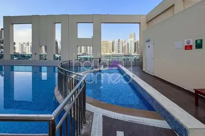 a large swimming pool on the roof of a building at Modern 1BR Oasis II Huge Layout II City Lights in Dubai