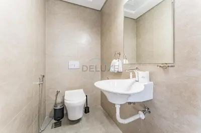 a bathroom with a sink and a toilet at Balcony Offering Community Views 1BR with Assistant Room, Walking Distance to Community Park , Pantheon Elysee , Jumeirah Village Circle by Deluxe Holiday Homes in Dubai