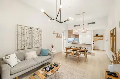 a living room with a couch and a table at FIRST CLASS 1BR Elegant Marina Hideaway in Dubai