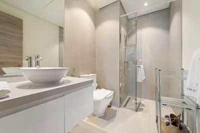 a bathroom with a sink and a toilet and a shower at FIRST CLASS 1BR Elegant Marina Hideaway in Dubai