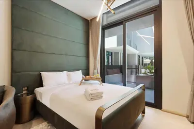 a bedroom with a large bed with a large window at Livbnb - Serene Studio with Private Terrace in JVC in Dubai