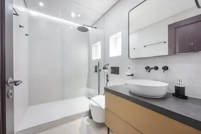 a bathroom with a sink and a toilet and a shower at AirDXB - Luxurious 2-Bedroom Apartment in Downtown - Sleeps 4 with Iconic Burj Khalifa Views in Dubai