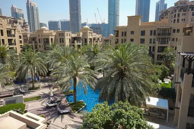 an overhead view of a pool in a city with palm trees at AirDXB - Luxurious 2-Bedroom Apartment in Downtown - Sleeps 4 with Iconic Burj Khalifa Views in Dubai