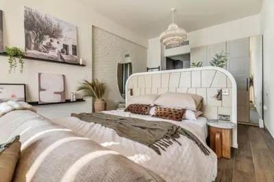 a bedroom with a large white bed and a couch at GuestReady - West Side Studios in Palm Jumeirah in Dubai