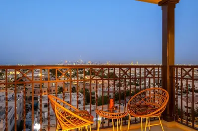 a balcony with a table and chairs and a view of a city at Premium 1BR with Iconic Skyline Views with Balcony & Pool in Dubai