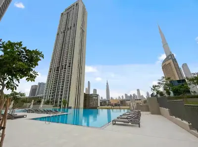 a large swimming pool with a view of the city at Vogue Downtown Views II with Direct Access to Dubai Mall Via a Climate Controlled Bridge, Two Bedroom Apartment with Balcony and Burj Khalifa View in Dubai