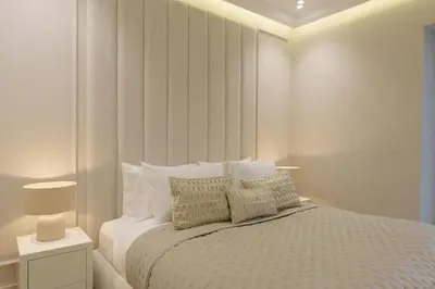 a white bedroom with a large bed with pillows at Daniels 2BR at Princess Tower with Sea View in Dubai