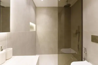 a bathroom with a shower and a toilet and a sink at Daniels 2BR at Princess Tower with Sea View in Dubai