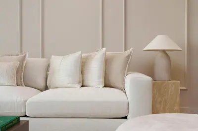 a white couch in a living room with a lamp at Daniels 1BR at Shoreline with Sea View in Dubai