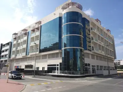 a building with a car parked in front of it at MK Residence JVC in Dubai