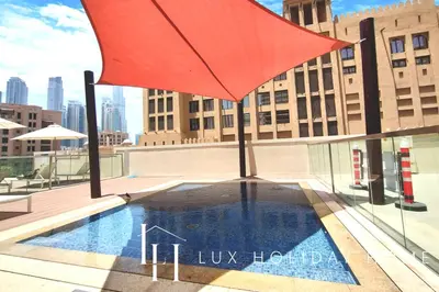 a large red umbrella sitting on top of a building at LUX The Executive Burj Khalifa View Suite 2 in Dubai